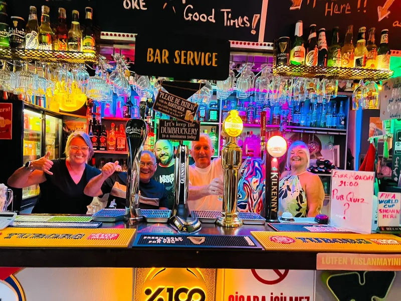 The team behind the bar at The Jukebox, Carlsberg, Guinness, Tuborg and Kilkenny taps in front